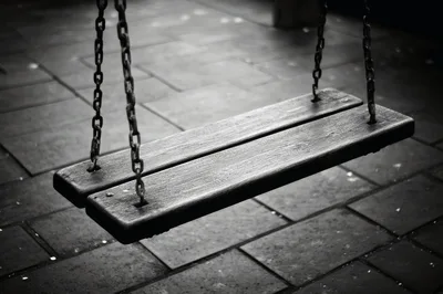 Empty Wooden Swing Hanging Over Stone Pavement