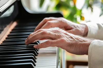 Elderly Person Playing Piano Keys