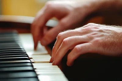 Close Up Of Hands Playing Piano Keys