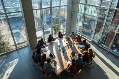 Diverse Business Team Collaborating in Modern Glass Conference Room