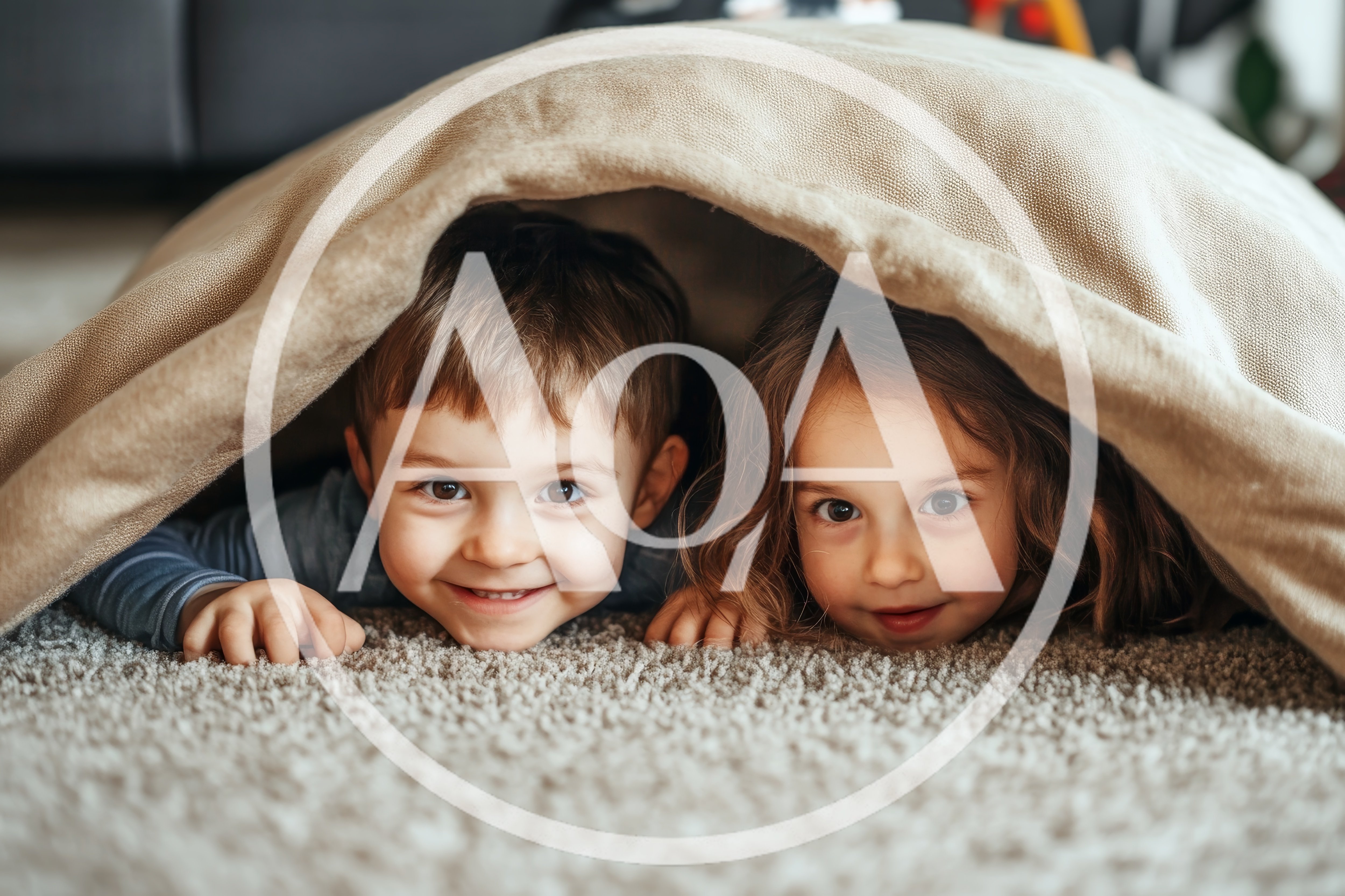 Young Children Playing Under A Blanket Fort