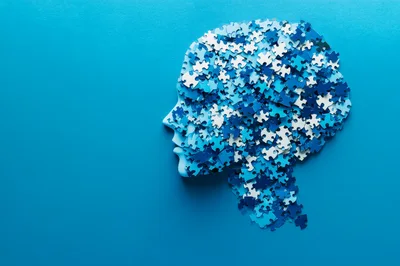 Human Head Silhouette Made Of Blue Jigsaw Puzzle Pieces
