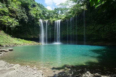 Scenic Waterfall Cascading Into A Turquoise Tropical Pool