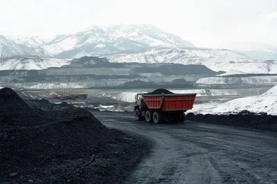 Heavy Duty Mining Truck Hauling Coal In Snowy Landscape