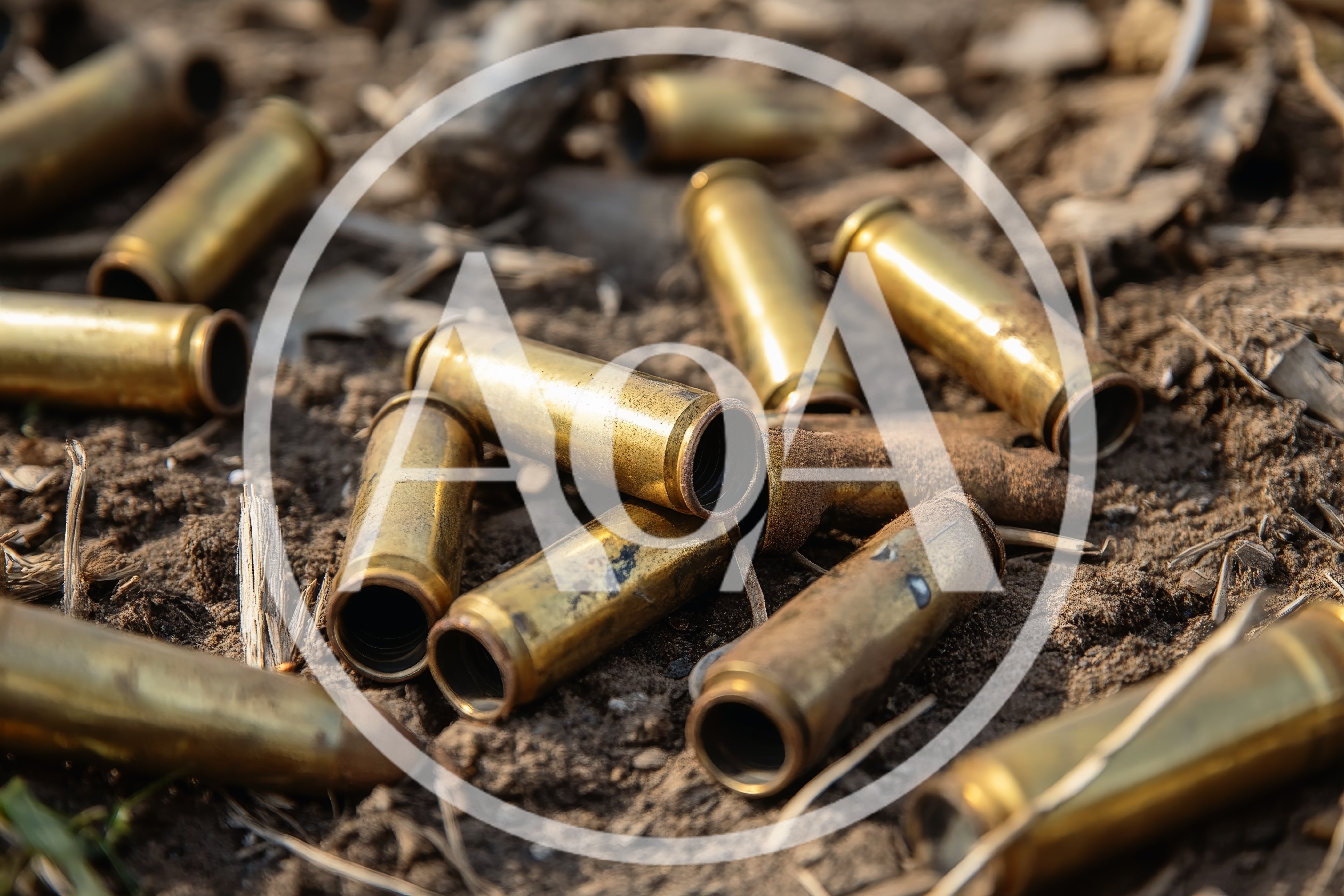 Spent Brass Bullet Casings Scattered On Dirt Ground