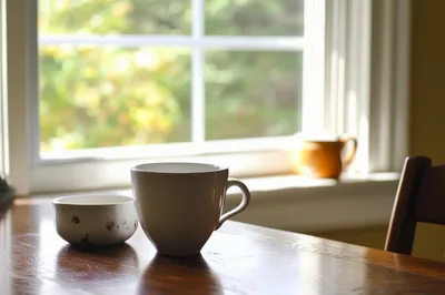 Coffee Mug And Small Bowl On Wooden Table