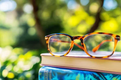 Tortoiseshell Reading Glasses Resting On Stacked Books