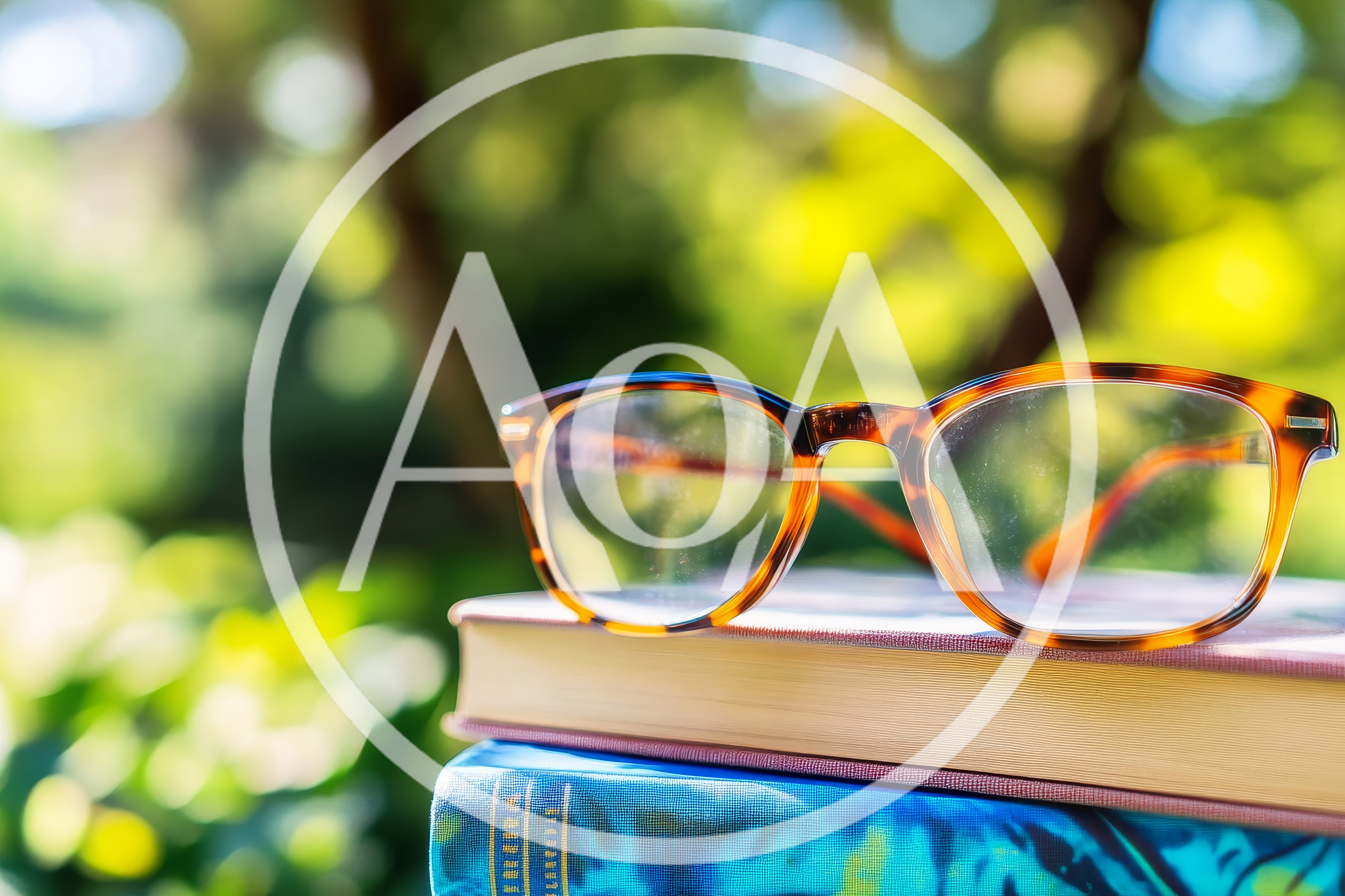 Tortoiseshell Reading Glasses Resting On Stacked Books