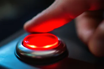 Finger Pressing A Glowing Red Button