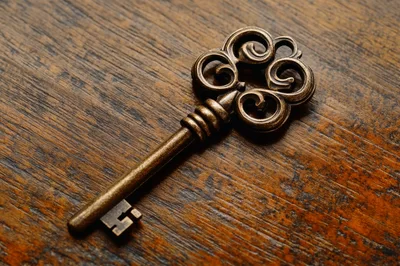 Antique Skeleton Key Resting On Dark Wooden Surface