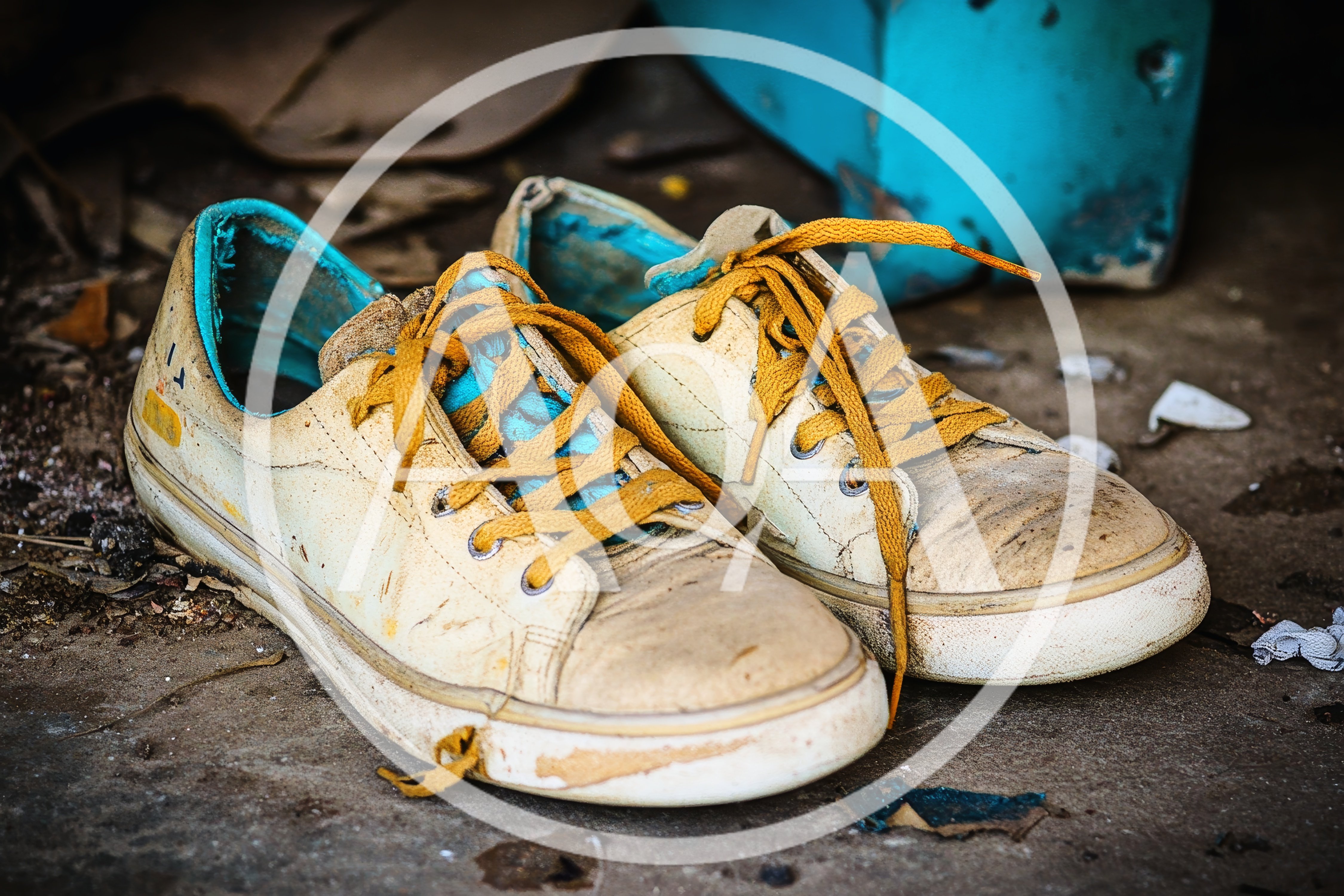 Pair Of Worn Out Yellow Sneakers On Concrete