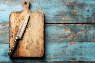 Chef Knife Resting On A Rustic Wooden Cutting Board