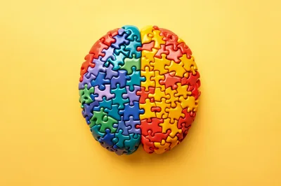 Brain Shaped Puzzle On Yellow Background