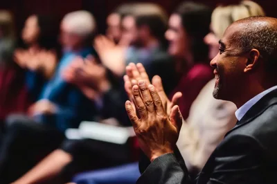 Diverse Audience Members Applauding During A Professional Conference