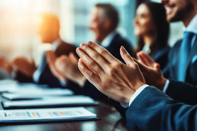 Business Professionals Applauding During A Corporate Meeting