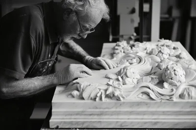 Elderly Sculptor Carving Intricate Floral Marble Relief