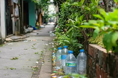 Plastic Water Bottles Discarded Along A Narrow Alleyway