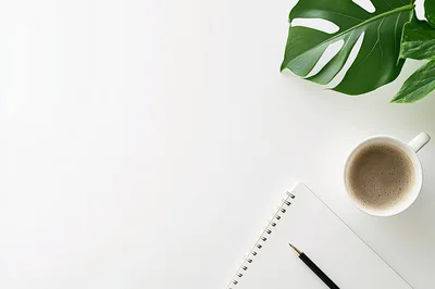Top View Of Notebook With Coffee And Monstera Leaf