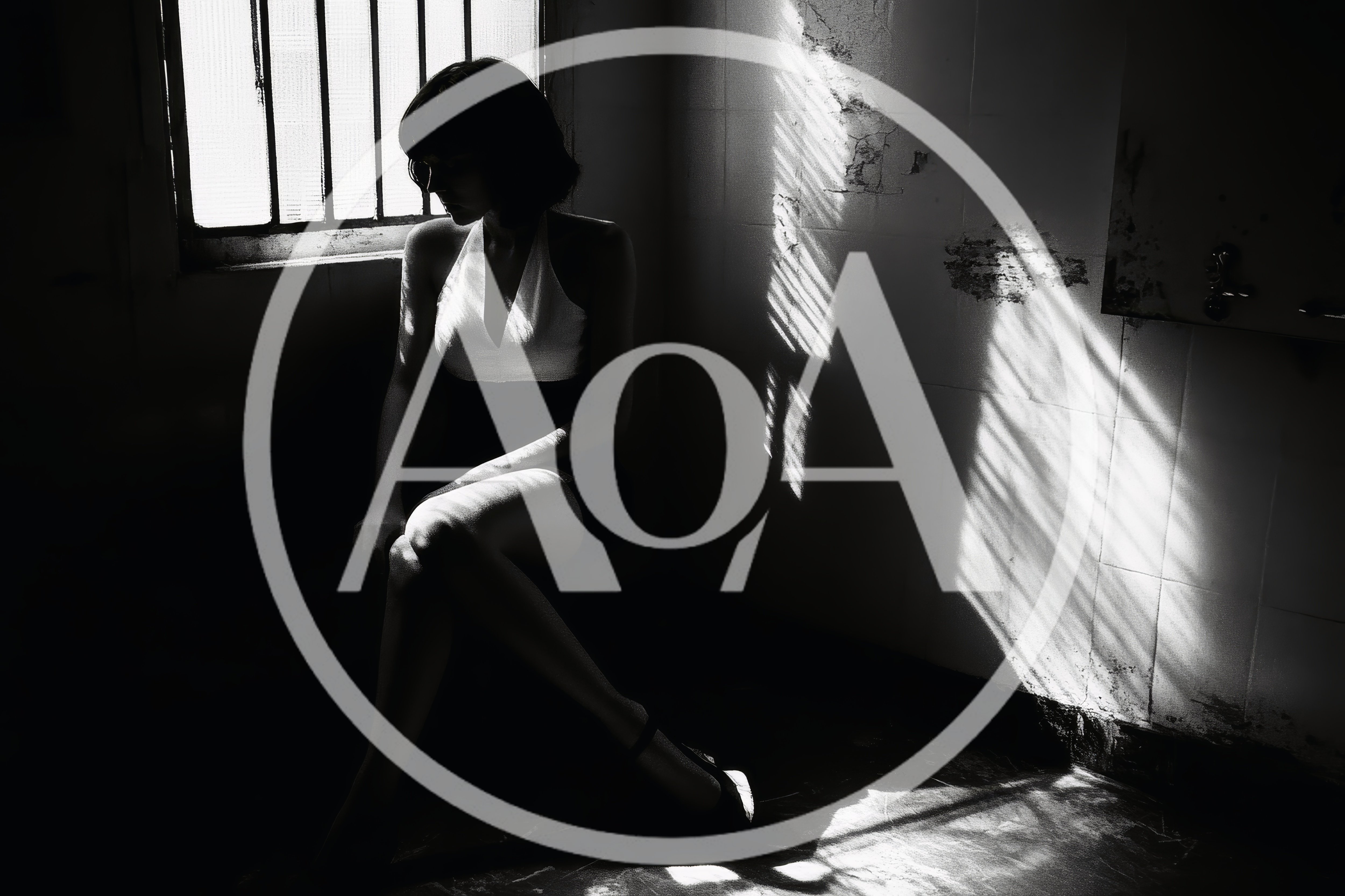 Silhouette of a Woman Sitting in a Dimly Lit Room