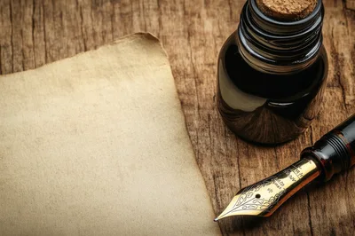 Fountain Pen and Ink Bottle on Vintage Paper