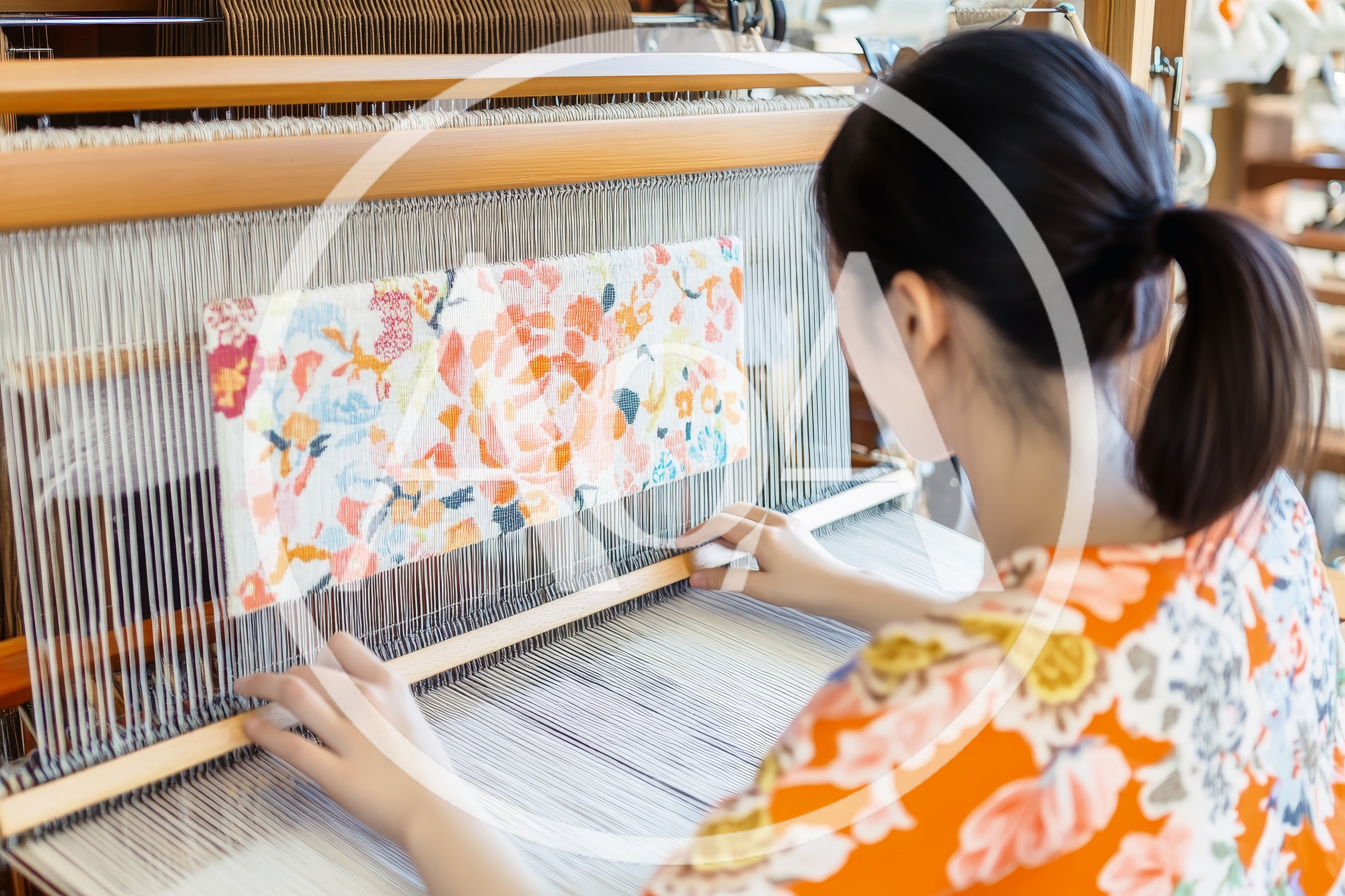 Young Woman Weaving Floral Fabric on Traditional Loom
