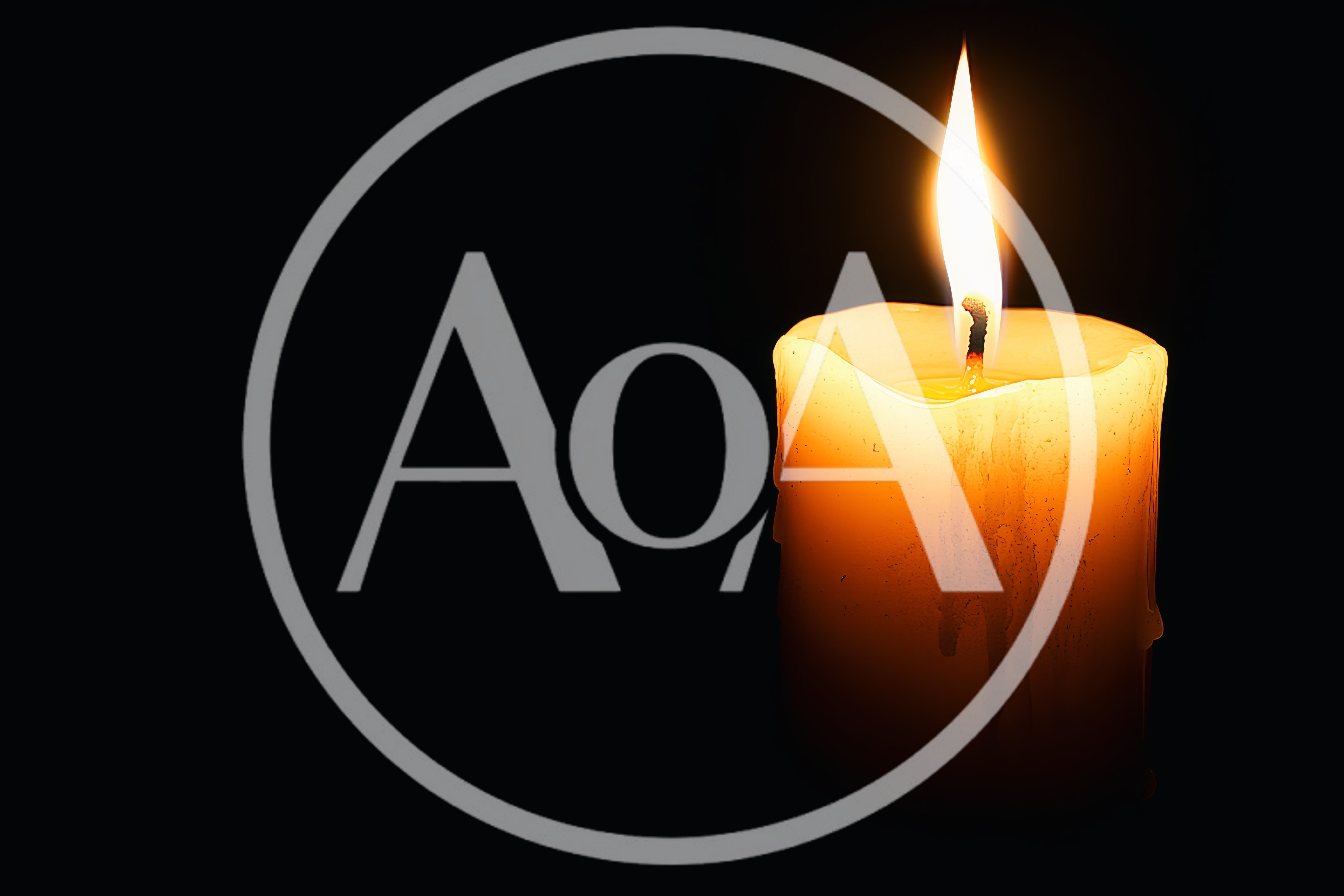 Single Lit Candle Burning In The Dark