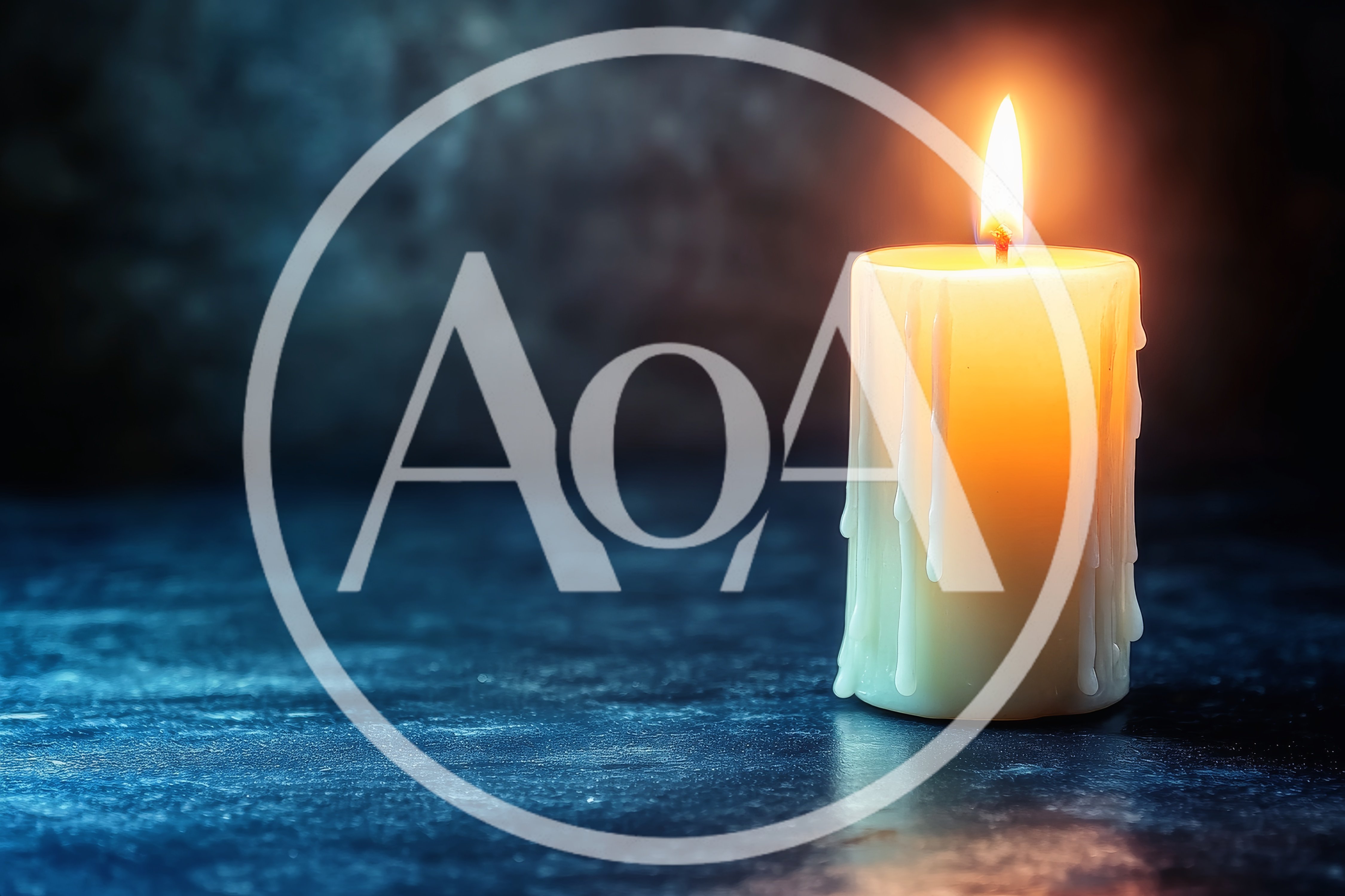 Lit Pillar Candle On Dark Textured Surface