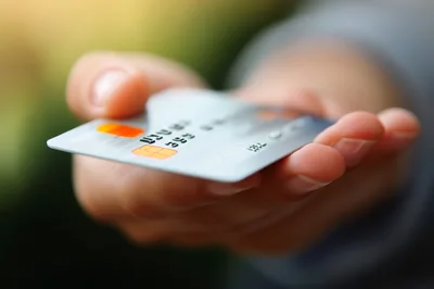Person Holding A Credit Card In Hand