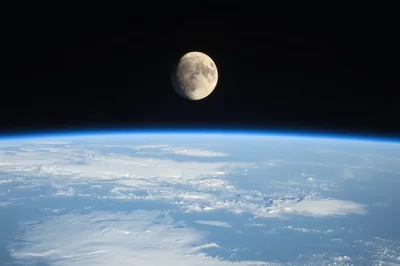 The Moon Rising Above Earths Horizon From Space