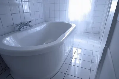Modern White Bathtub In A Bright Tiled Bathroom