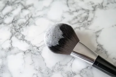 Cleaning A Large Makeup Brush With Soap Foam