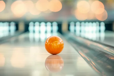Orange Bowling Ball Rolling Down Lane