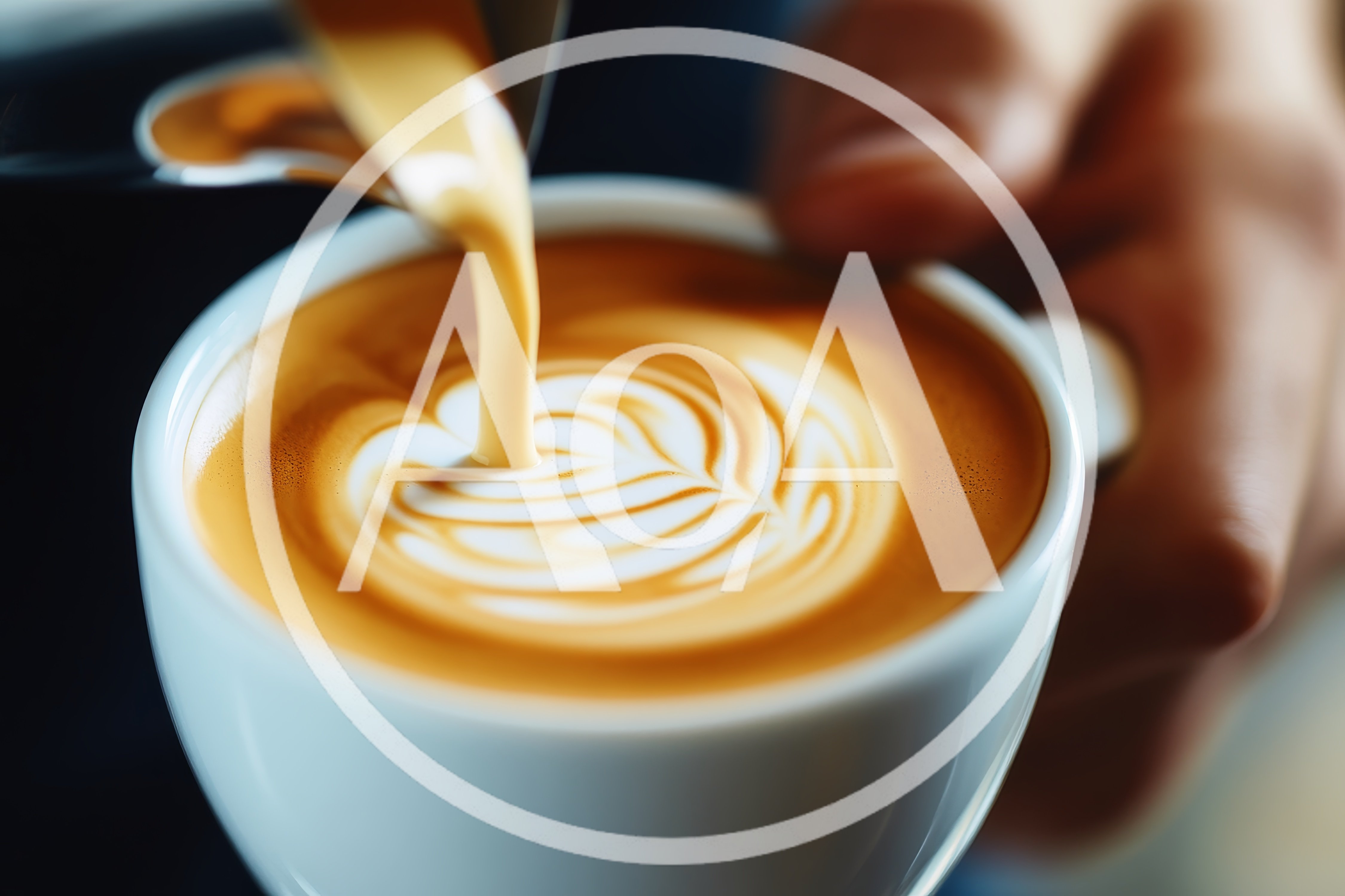 Barista Pouring Steamed Milk Into A Latte Cup