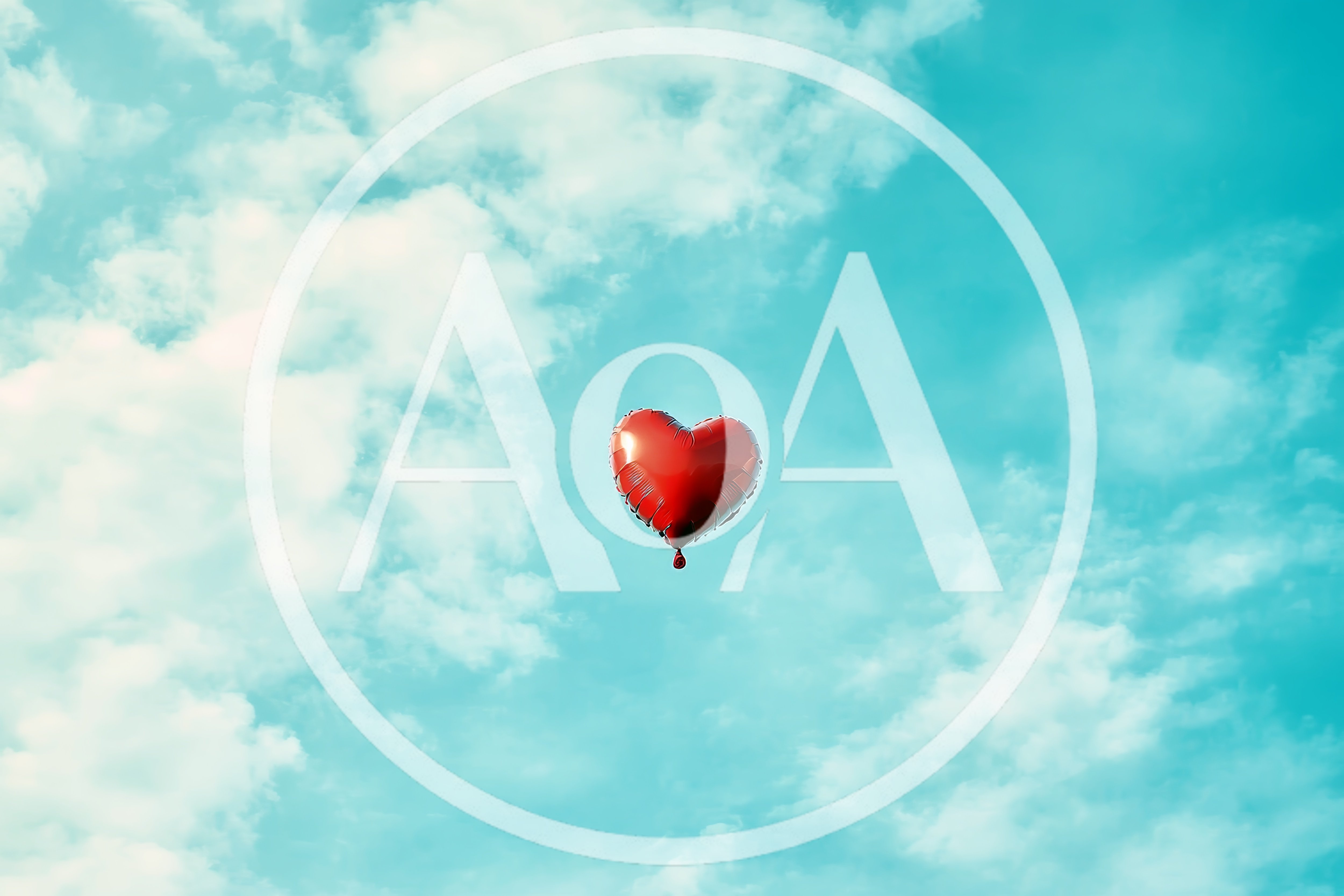 Red Heart Shaped Balloon Floating In Blue Sky