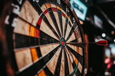 Dart Hitting The Bullseye On A Dartboard