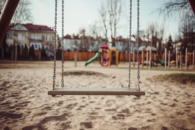 Empty Wooden Swing Set in a Public Playground