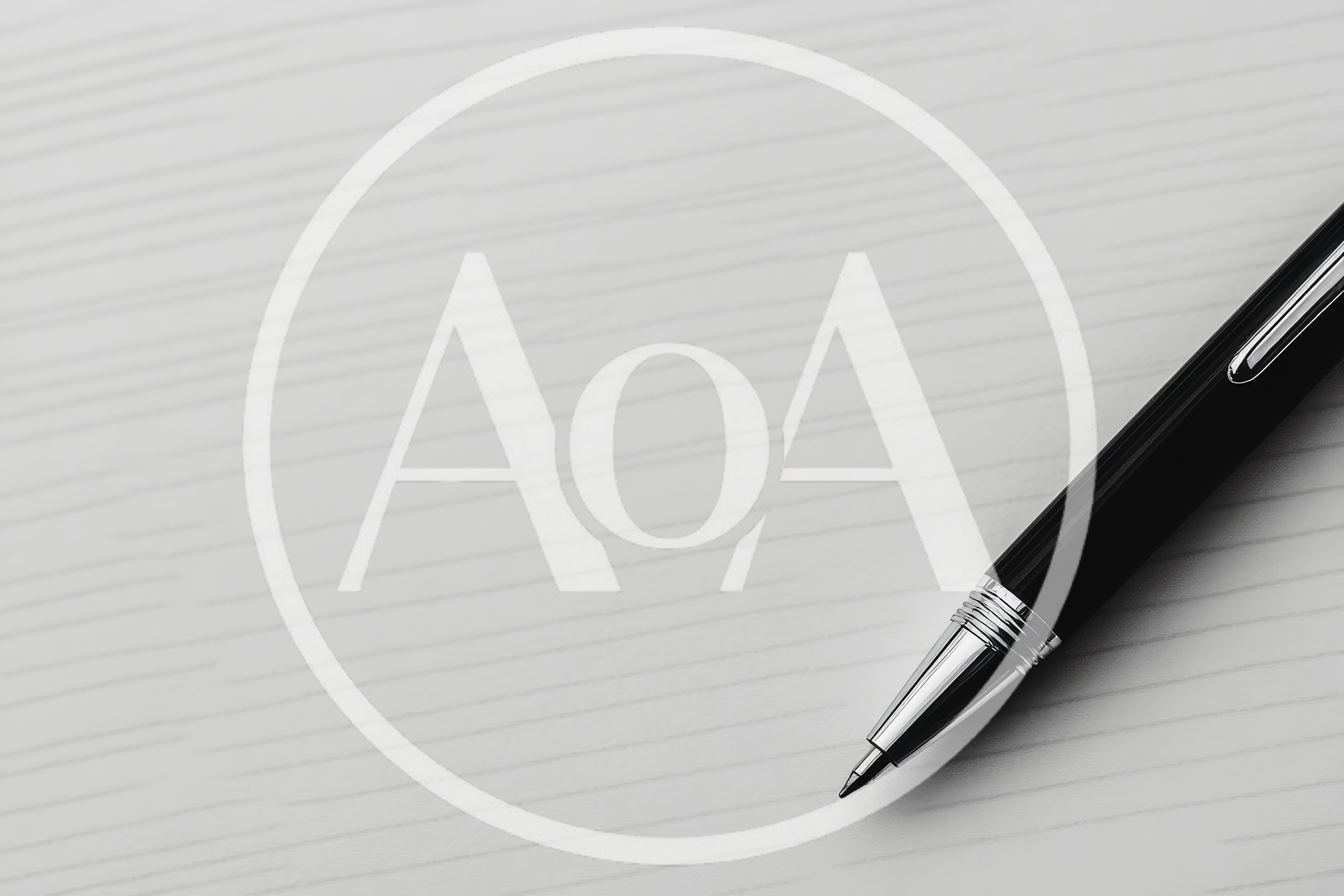 Black Rollerball Pen Resting On White Textured Surface