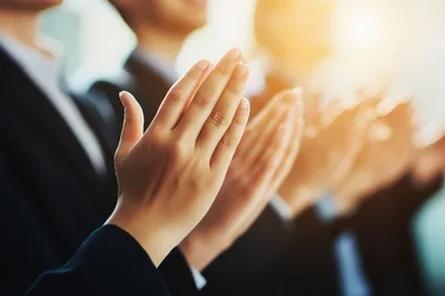 Business Professionals Clapping Hands In A Conference
