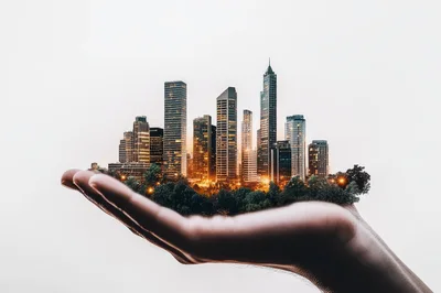 Conceptual Cityscape Held In A Human Hand