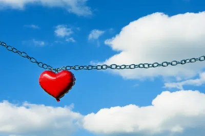 Red Heart Balloon Hanging From A Metal Chain