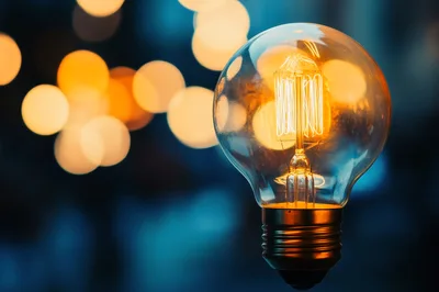 Glowing Vintage Edison Light Bulb Against Blurred Background