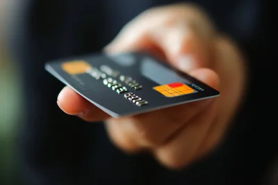 Person Holding A Black Credit Card