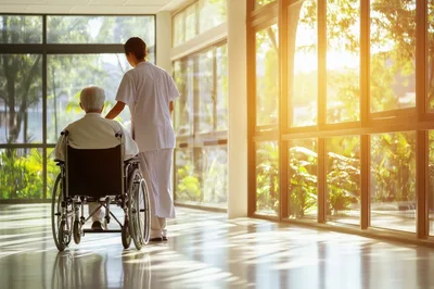 Nurse Assisting Elderly Patient in Wheelchair