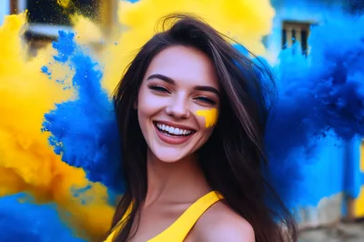 Young Woman Smiling Amidst Blue And Yellow Smoke