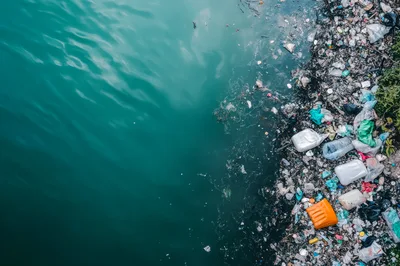 Aerial View Of Plastic Pollution On Riverbank