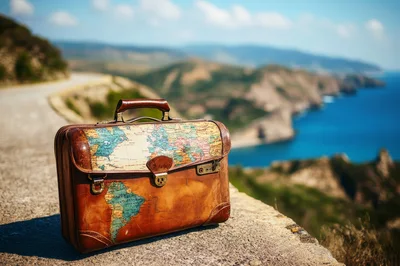 Vintage Map Suitcase On A Scenic Coastal Road