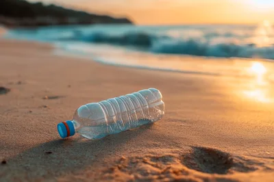 Plastic Water Bottle Abandoned On A Sandy Beach