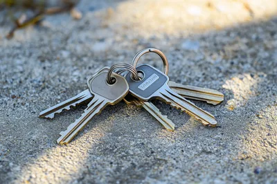Bunch of Metal Keys on Concrete Surface