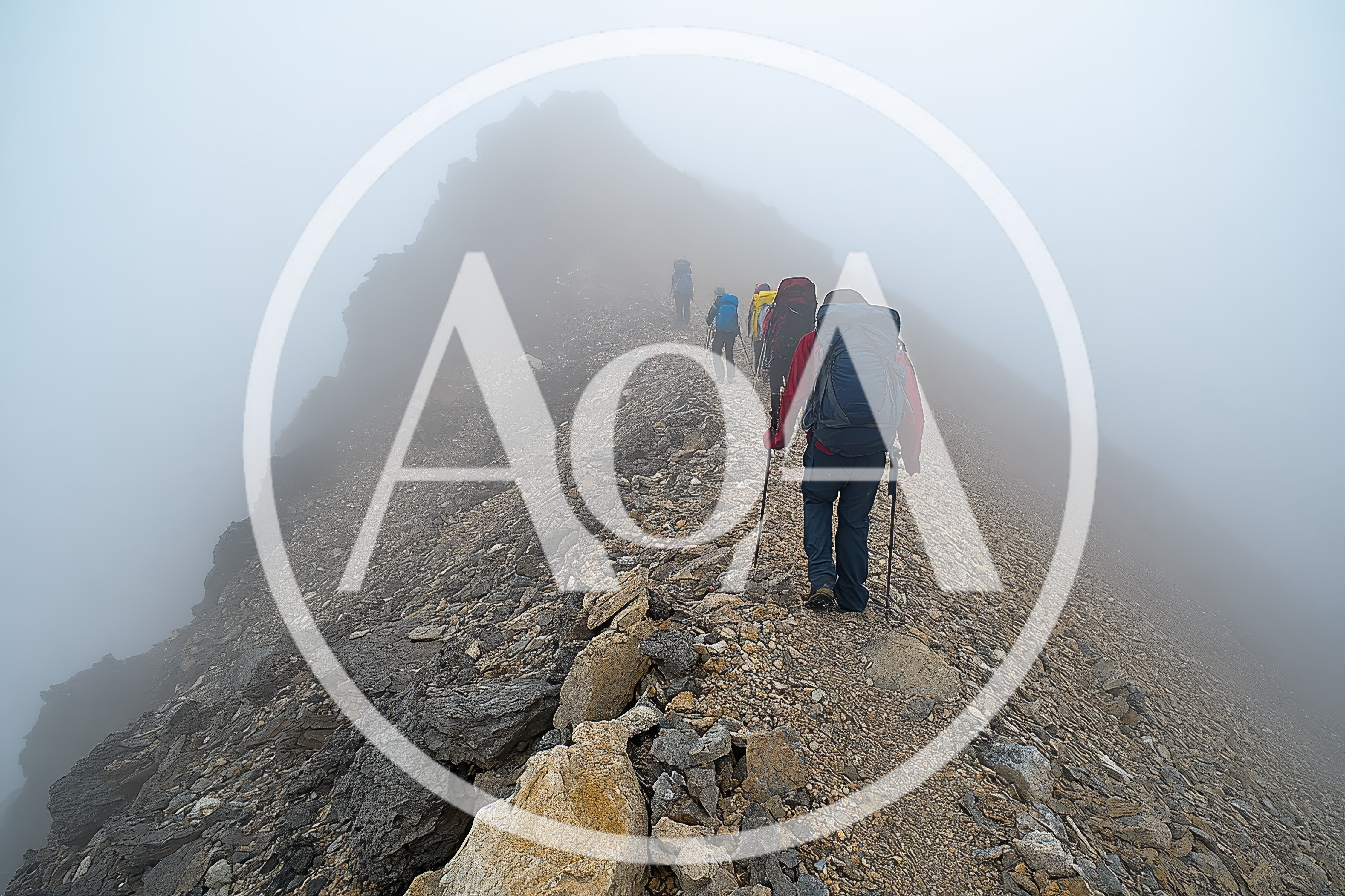 Group Of Hikers Trekking Along A Foggy Mountain Ridge