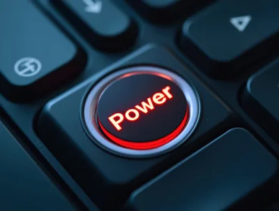 Glowing Red Power Button On A Computer Keyboard